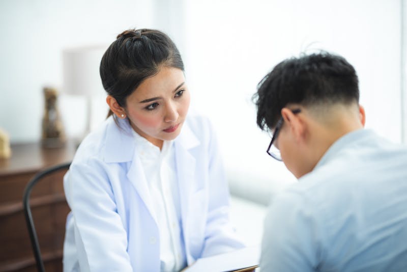 Doctor consulting with patient in modern medical office