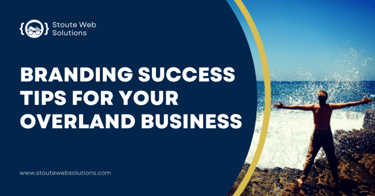 A young man stands with arms open-wide in front of the sea celebrating success.