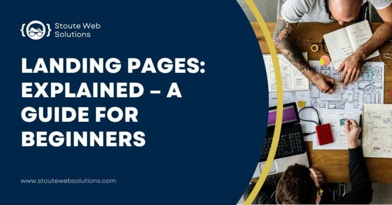 A top view of male colleagues working on printed web designs.