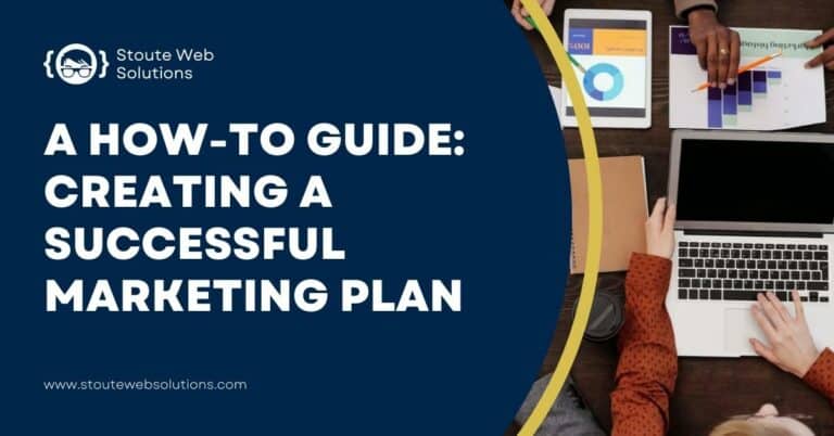 A top view of an office table where employees use laptop and printed data.