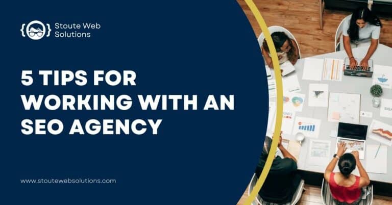 A top-view of an SEO Agency personnel looking at some printed data on a wide table.
