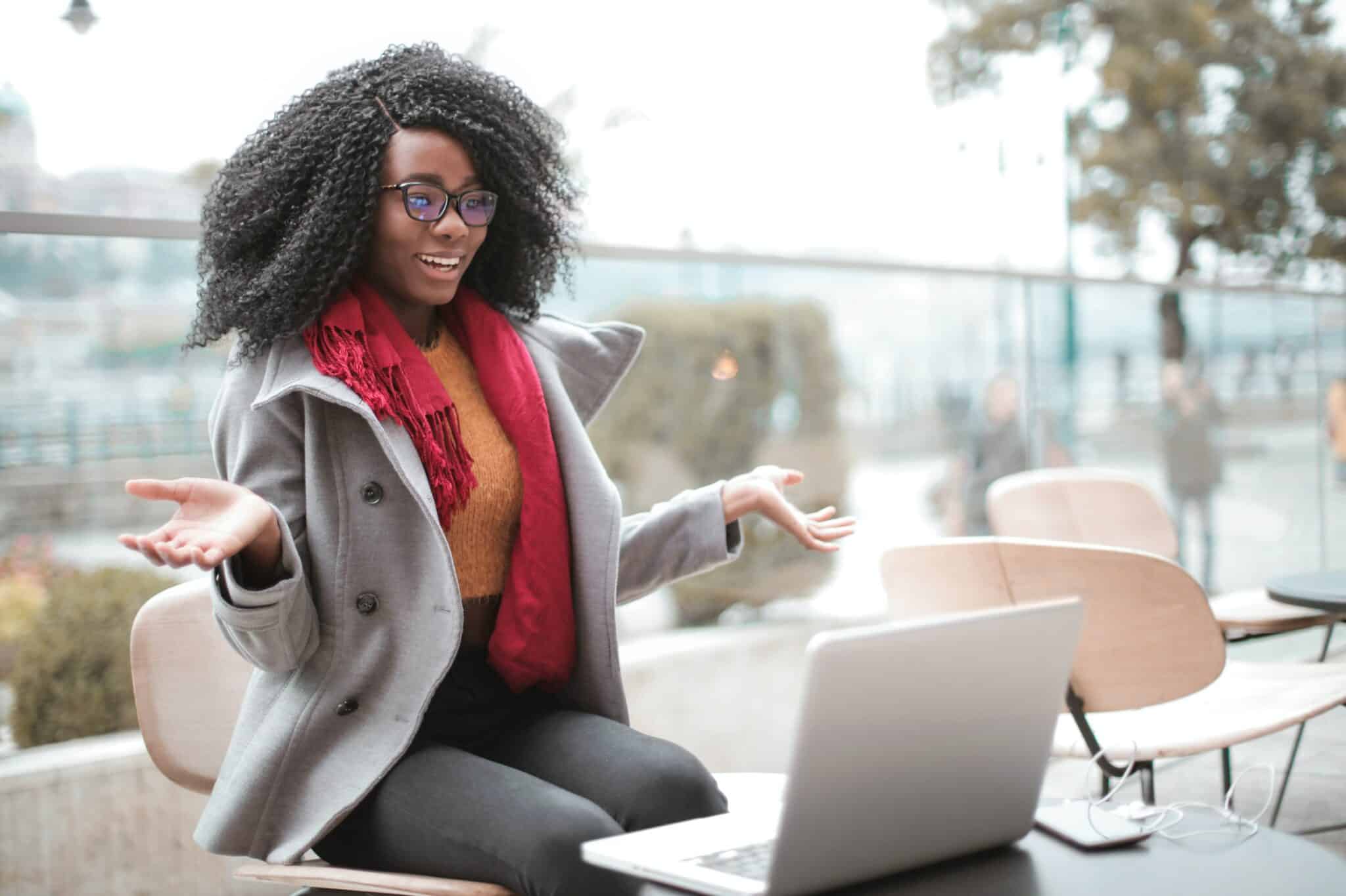 A black female entrepreneur creates an FAQ video for her customers.