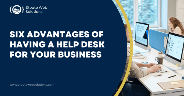 Group of employees working in front of computers on a table.