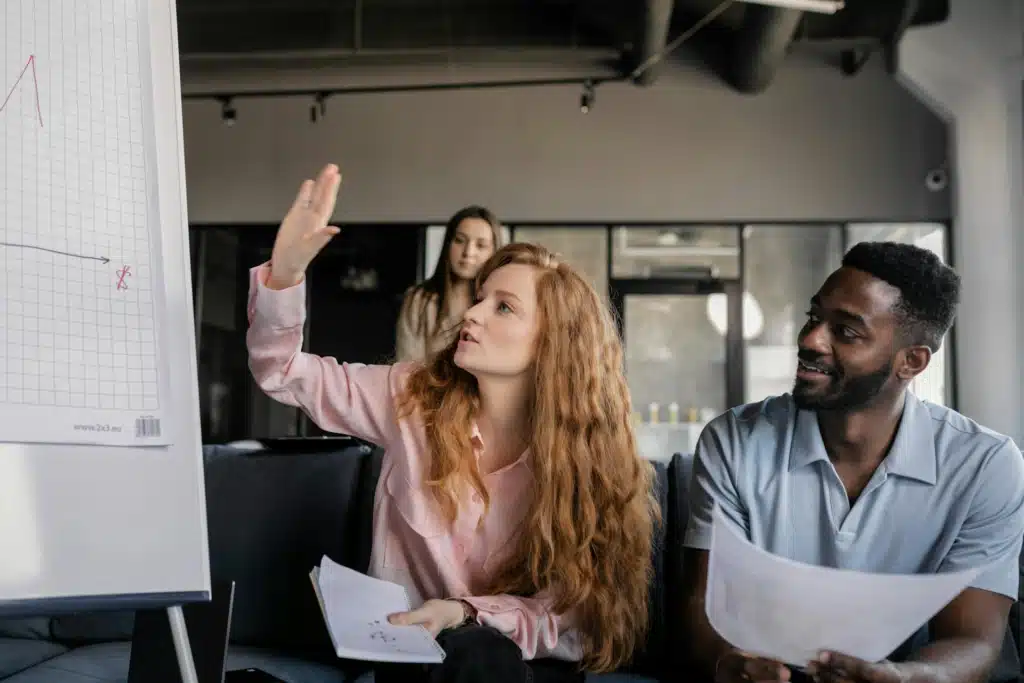 Woman in Pink Long Sleeve Shirt Holding White Paper